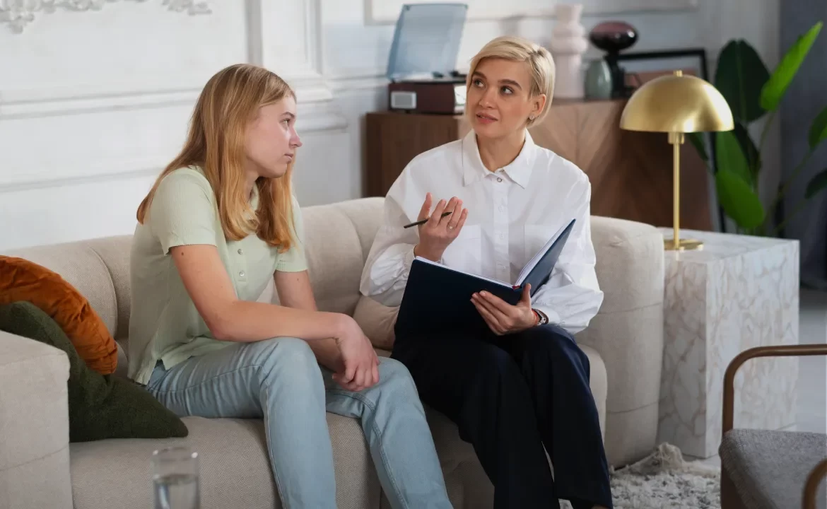 Teenage girl talking with a counsellor