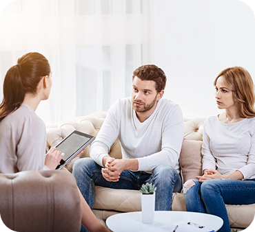 Couple talking with a therapist in a counselling session